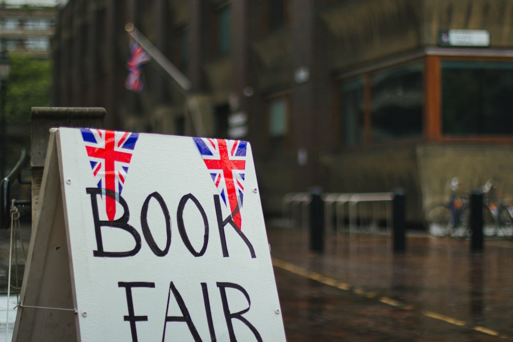 a sign that says book fair on a rainy day