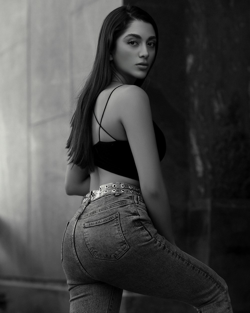 a woman in high waist jeans posing for a picture