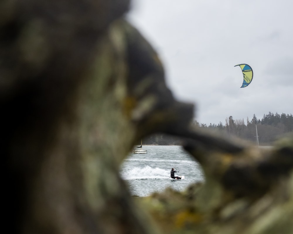 a person parasailing in the ocean on a cloudy day