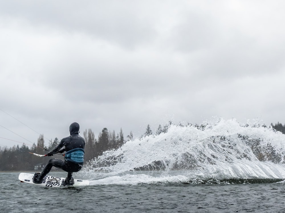 a man riding a board on top of a body of water