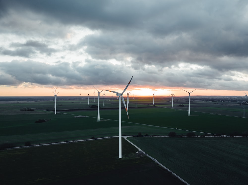 a wind farm with several windmills on a cloudy day