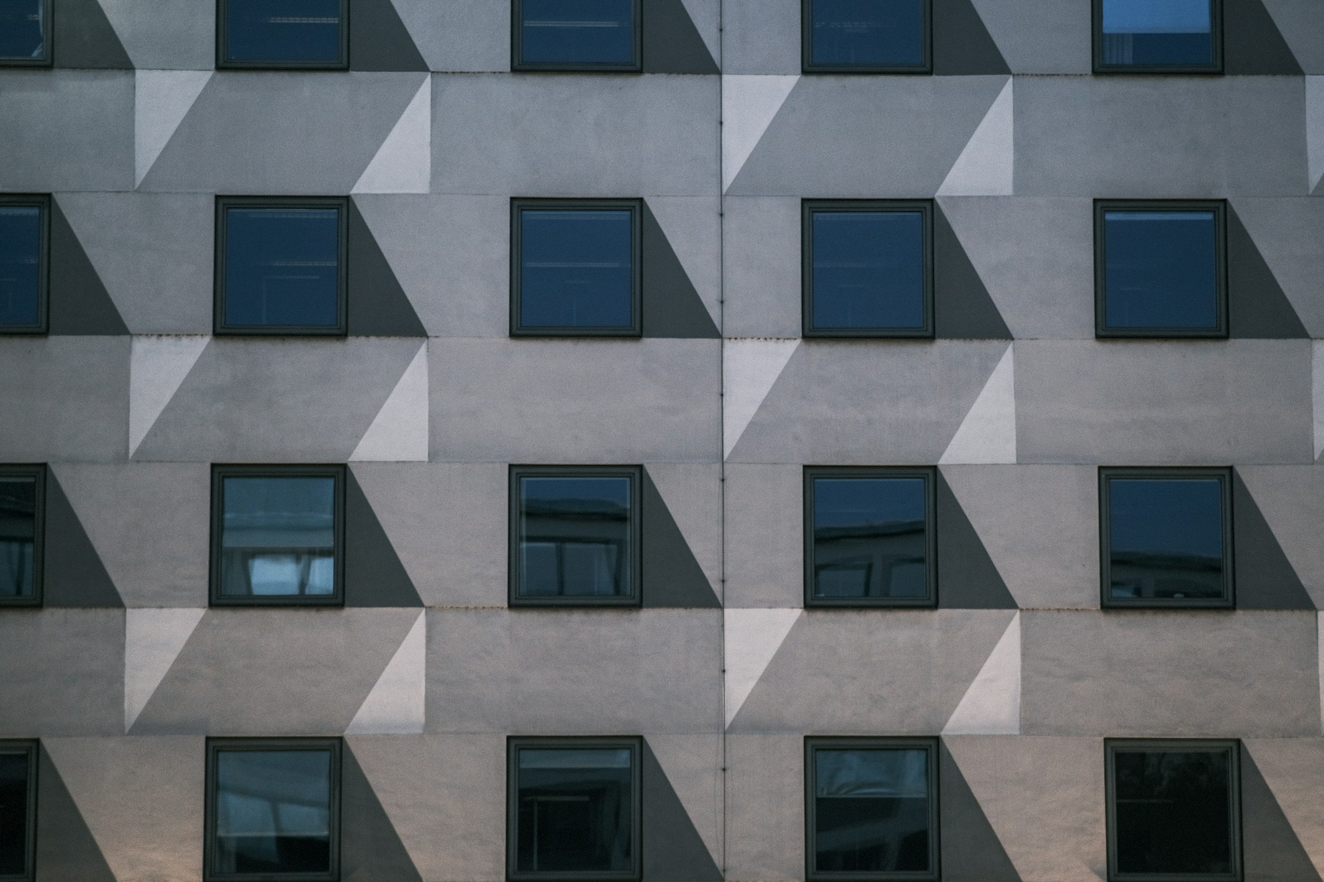 a tall building with many windows and a clock