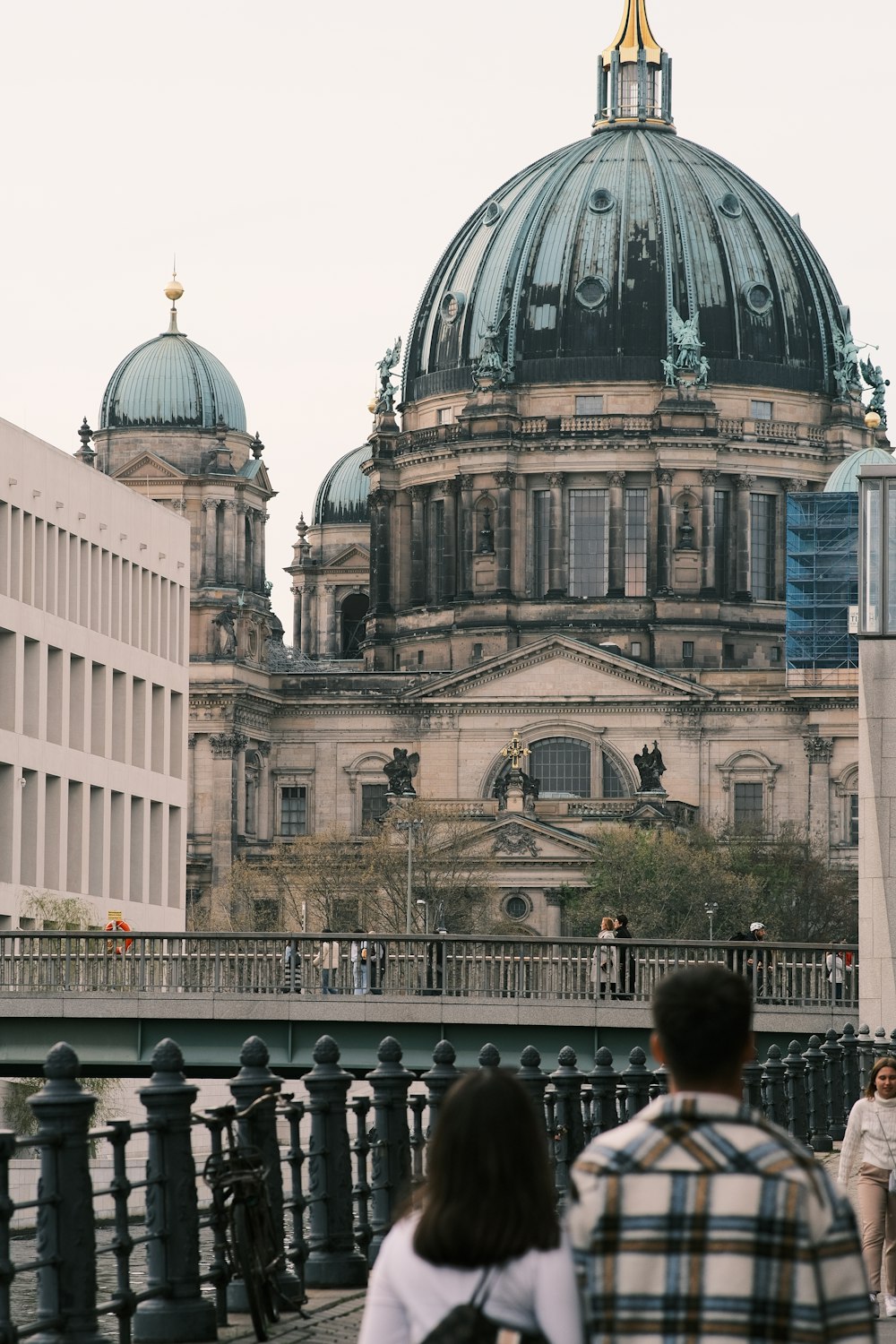 a couple of people walking across a bridge