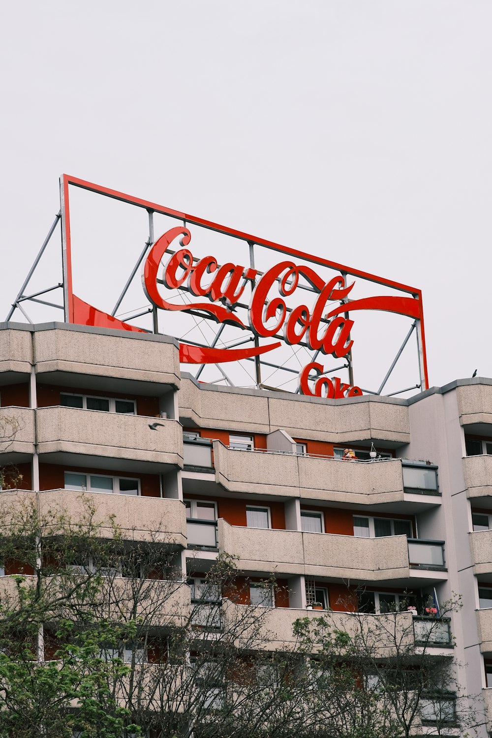 a large coca cola sign on top of a building