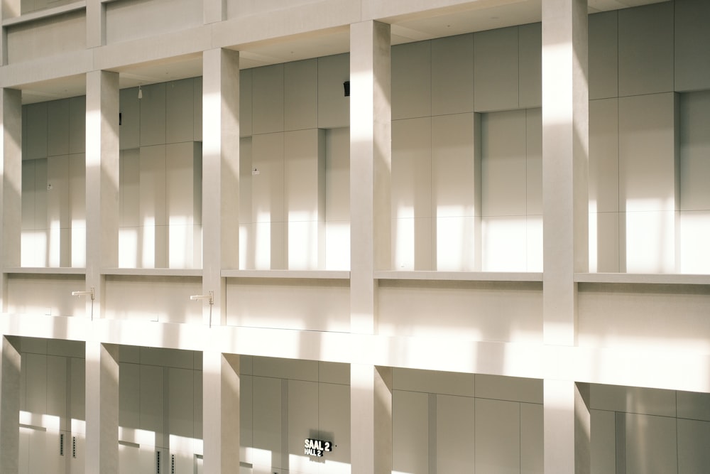 a row of white bookshelves in a building