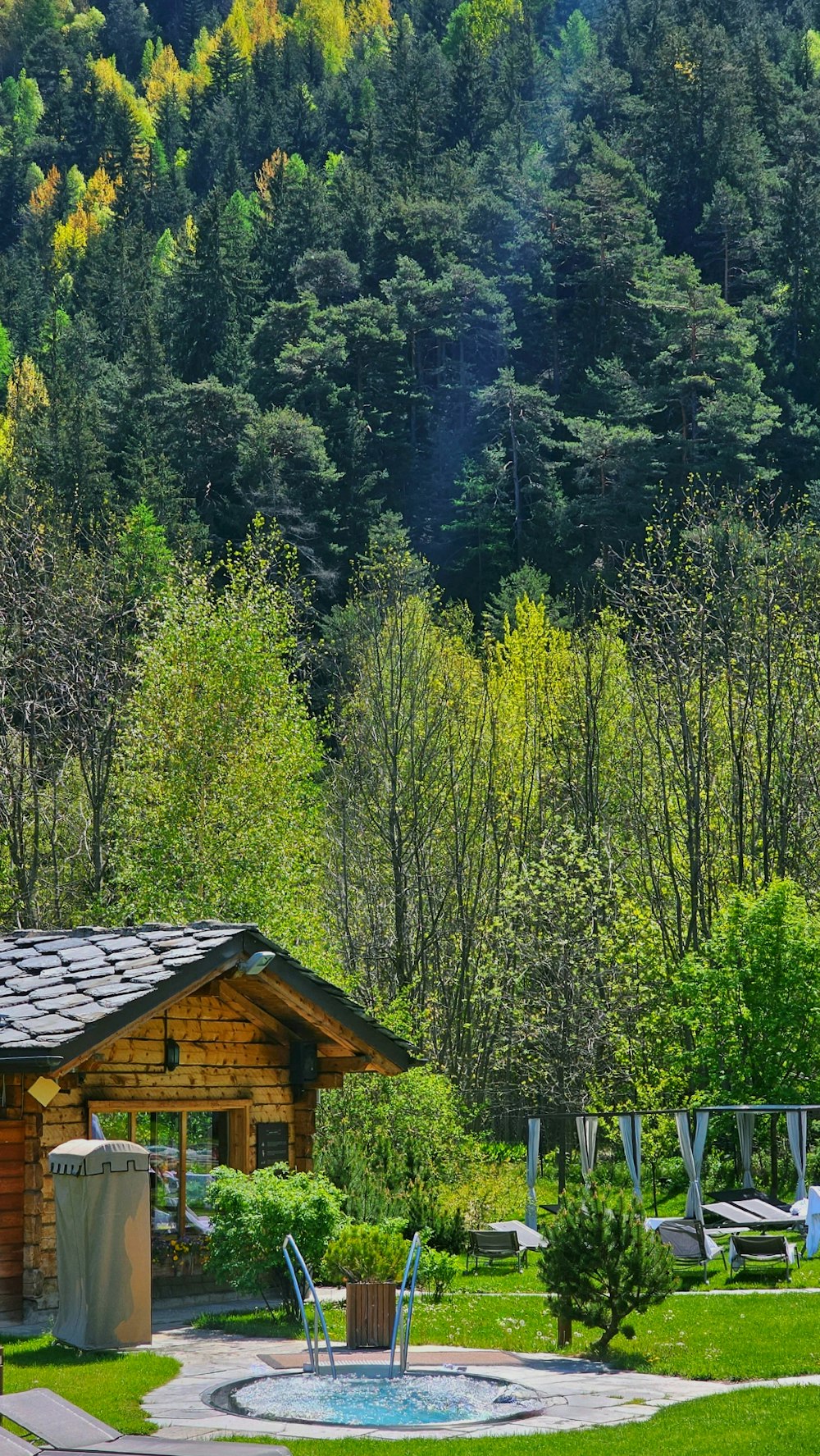 a small wooden cabin with a pool in the middle of it