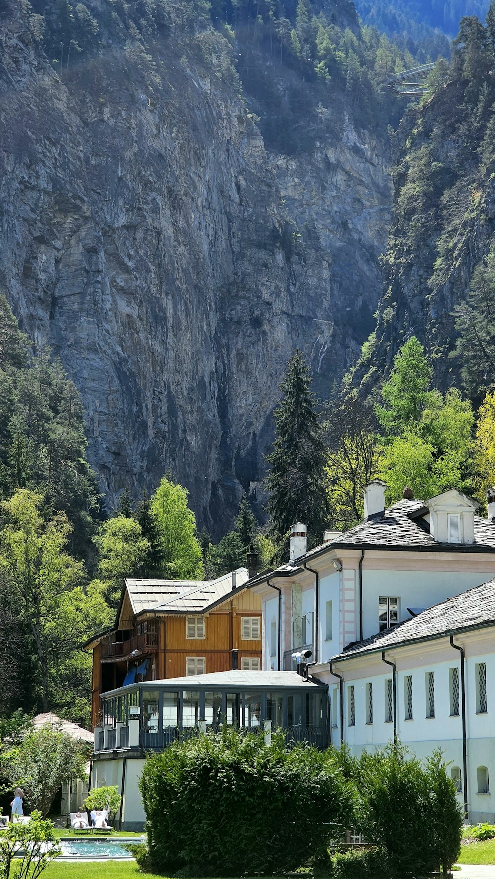 a white building with a mountain in the background