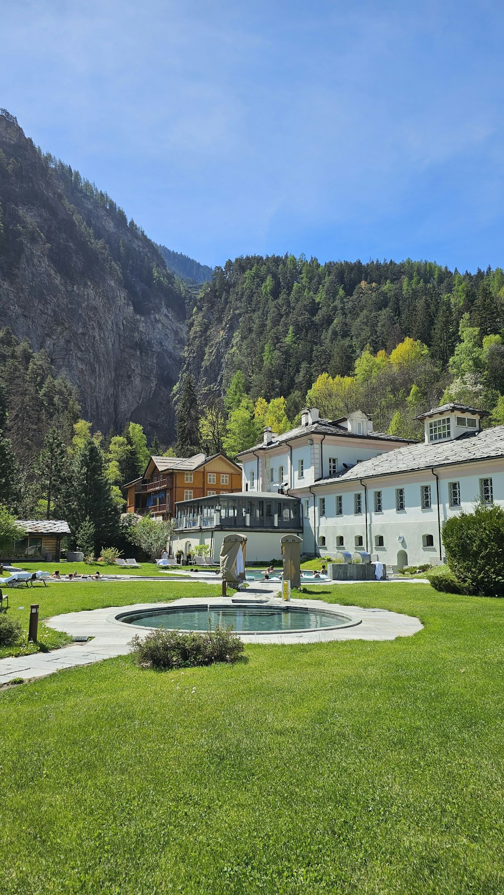 a building with a fountain in the middle of a field