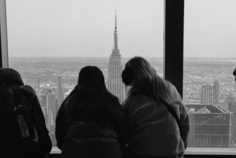 a group of people standing in front of a window