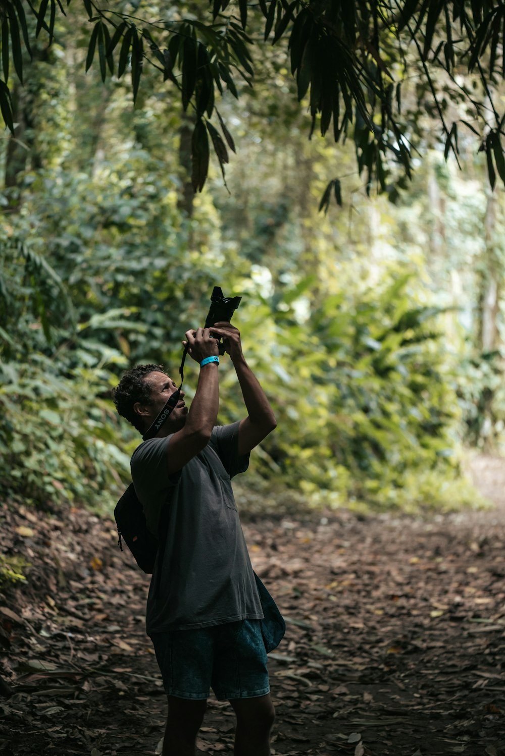 a man taking a picture of himself in the woods