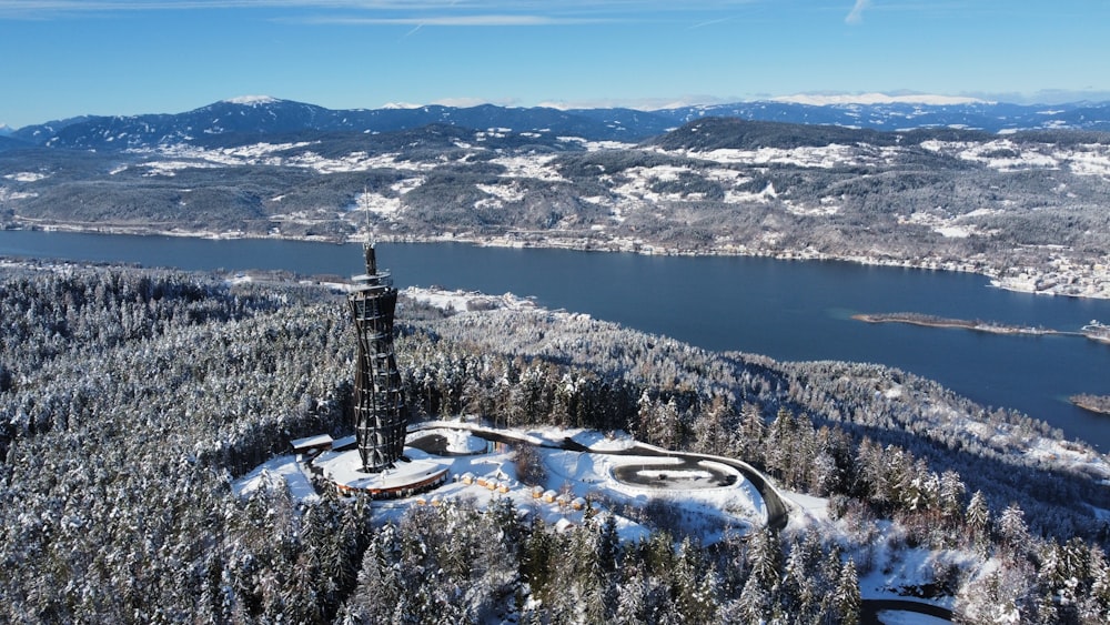 an aerial view of a tower in the middle of a forest