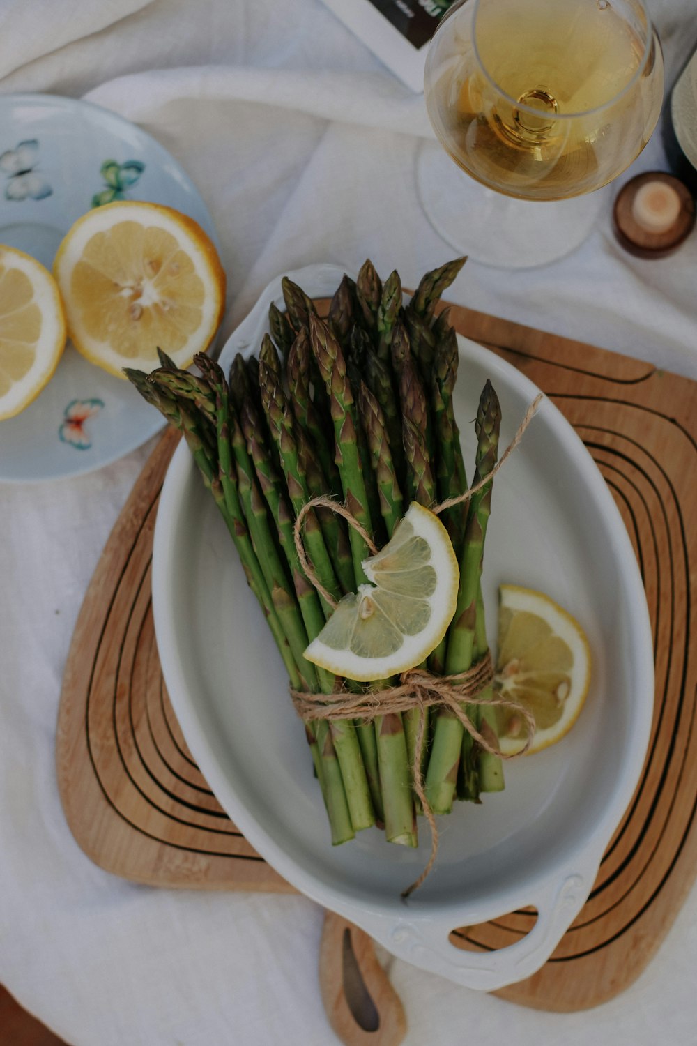 a white plate topped with asparagus and lemon slices