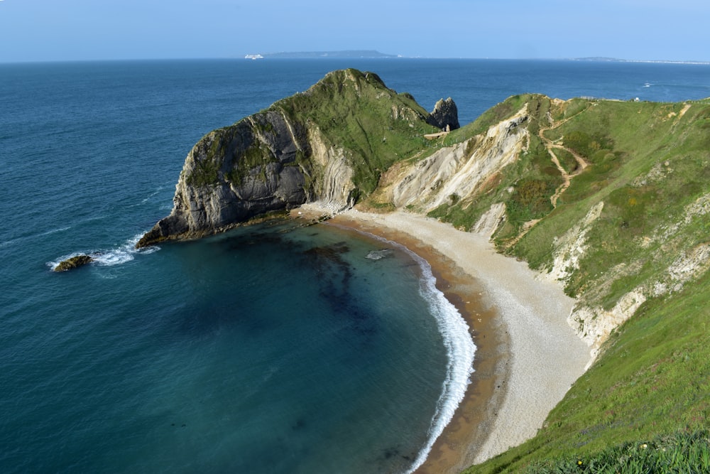 a view of a beach with a cliff in the background