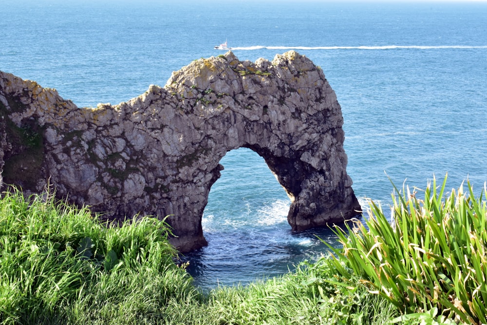 a large rock formation in the middle of a body of water