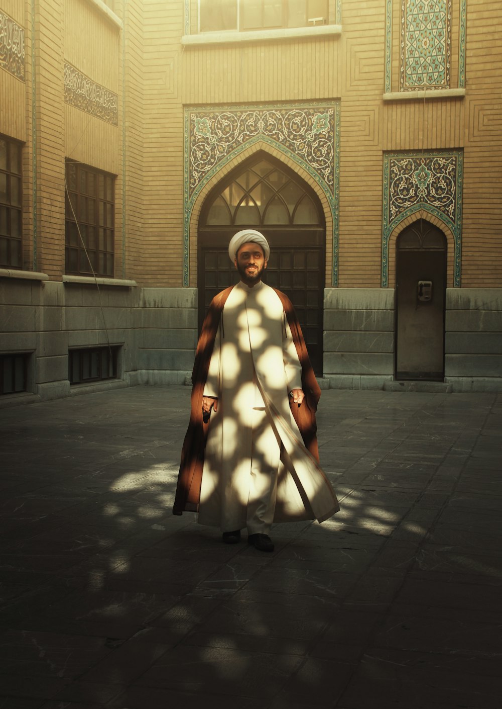 a woman in a white dress standing in front of a building