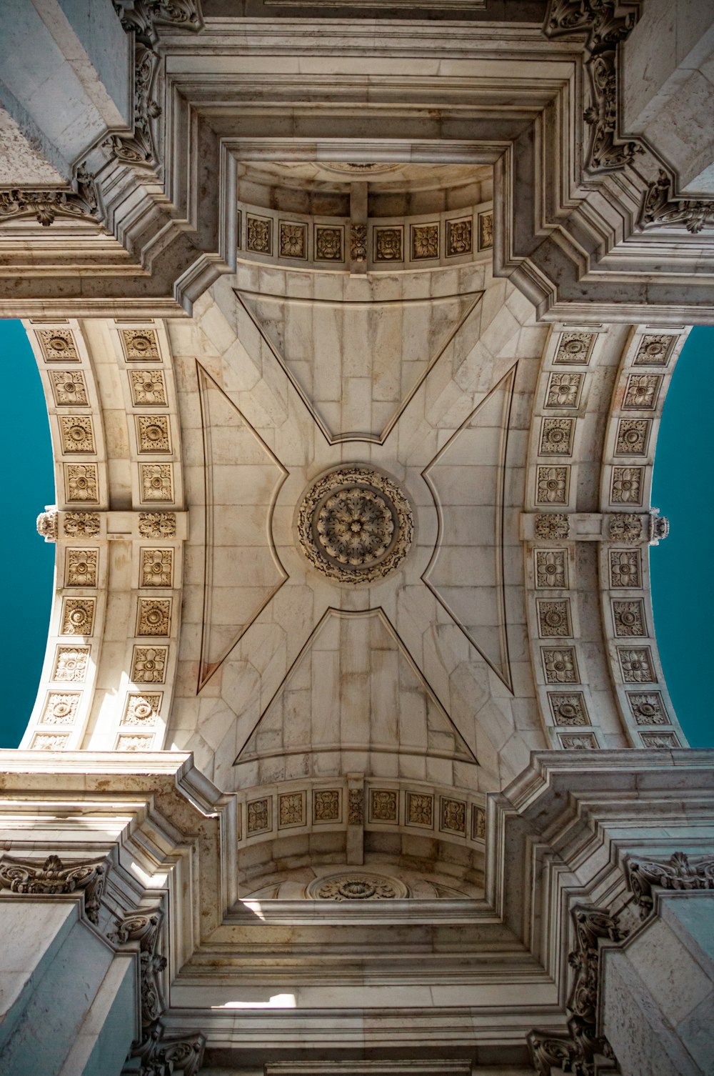 the ceiling of a building with a clock on it