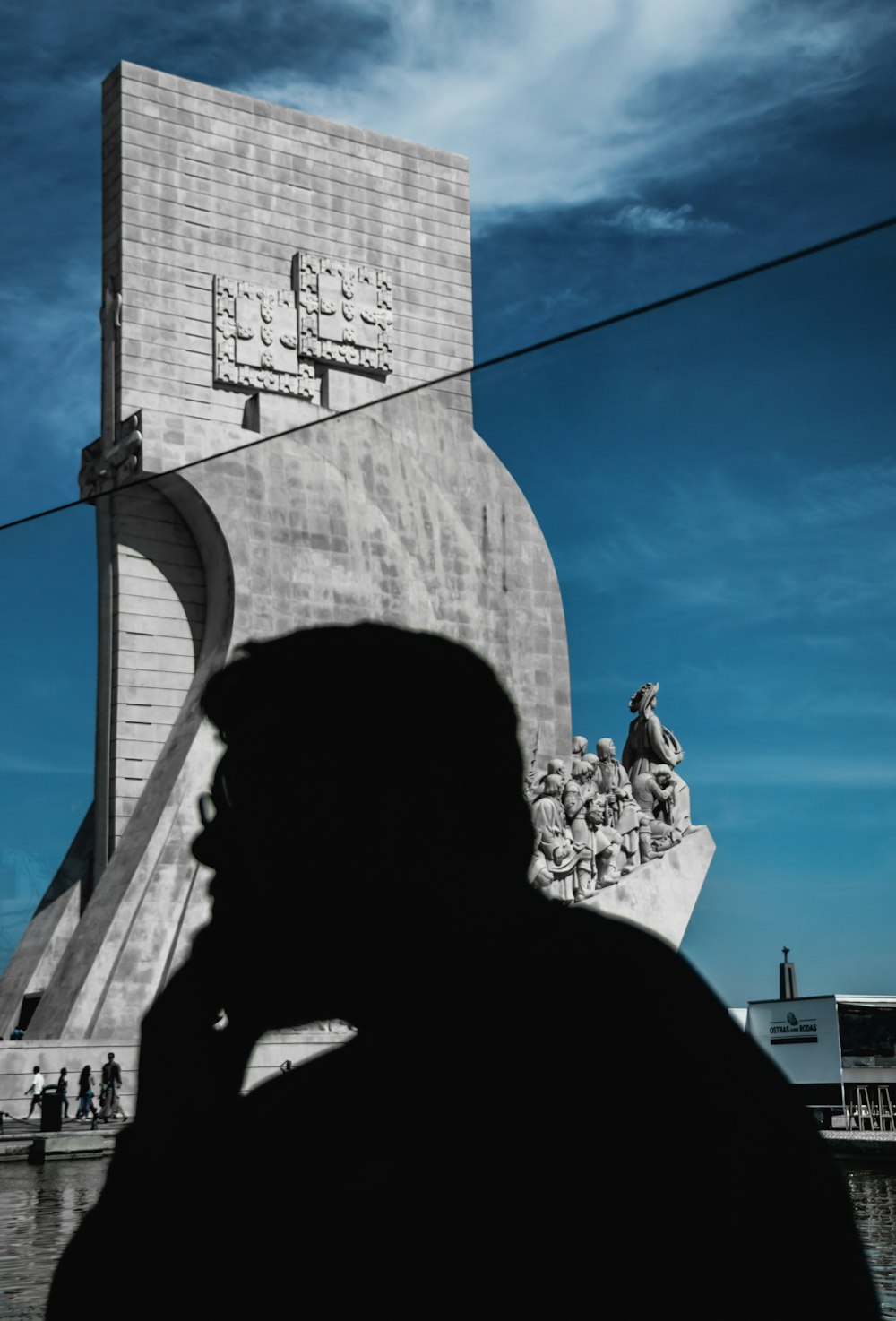 a man standing in front of a monument