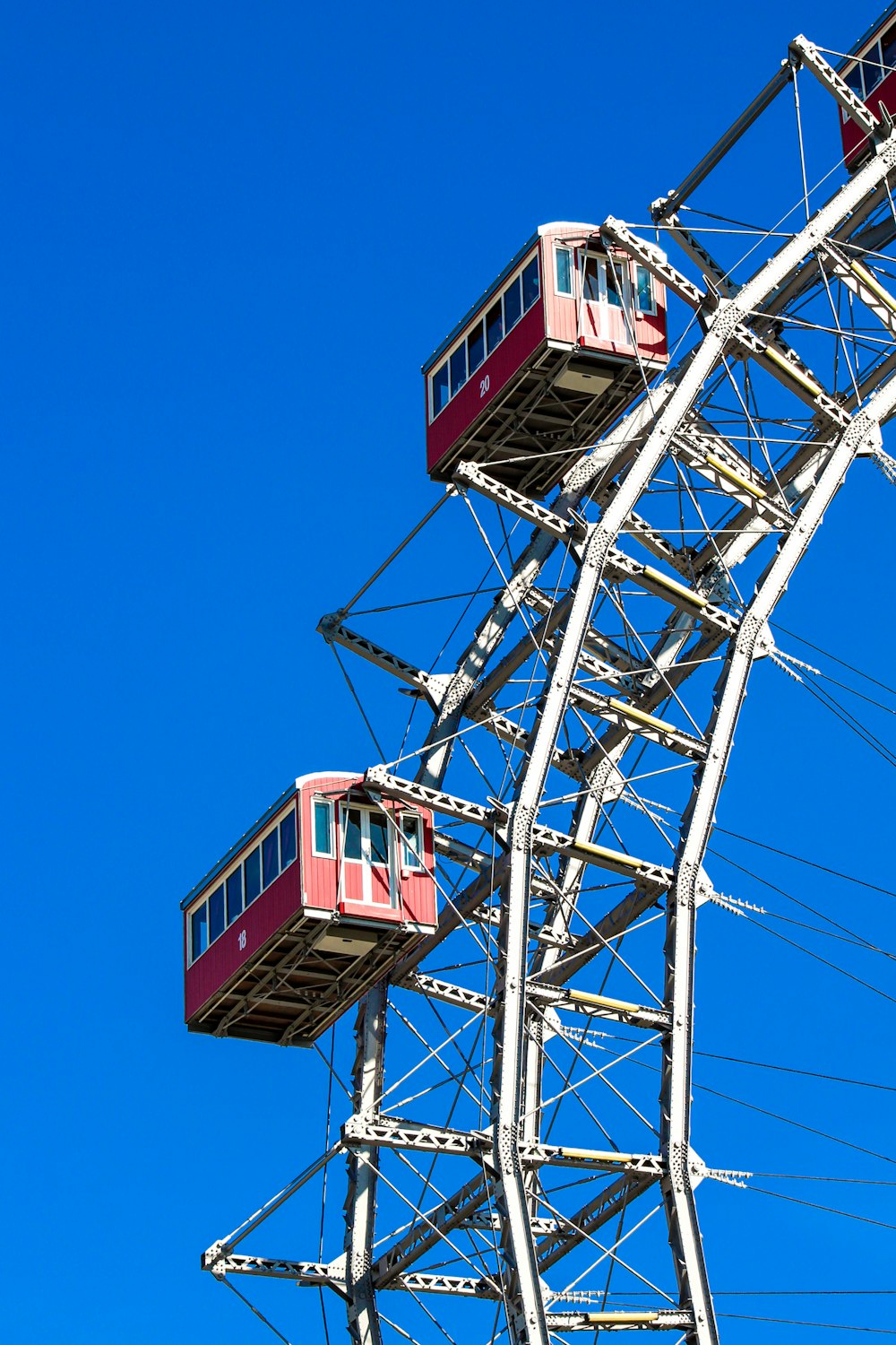 a red and white ferris wheel against a blue sky