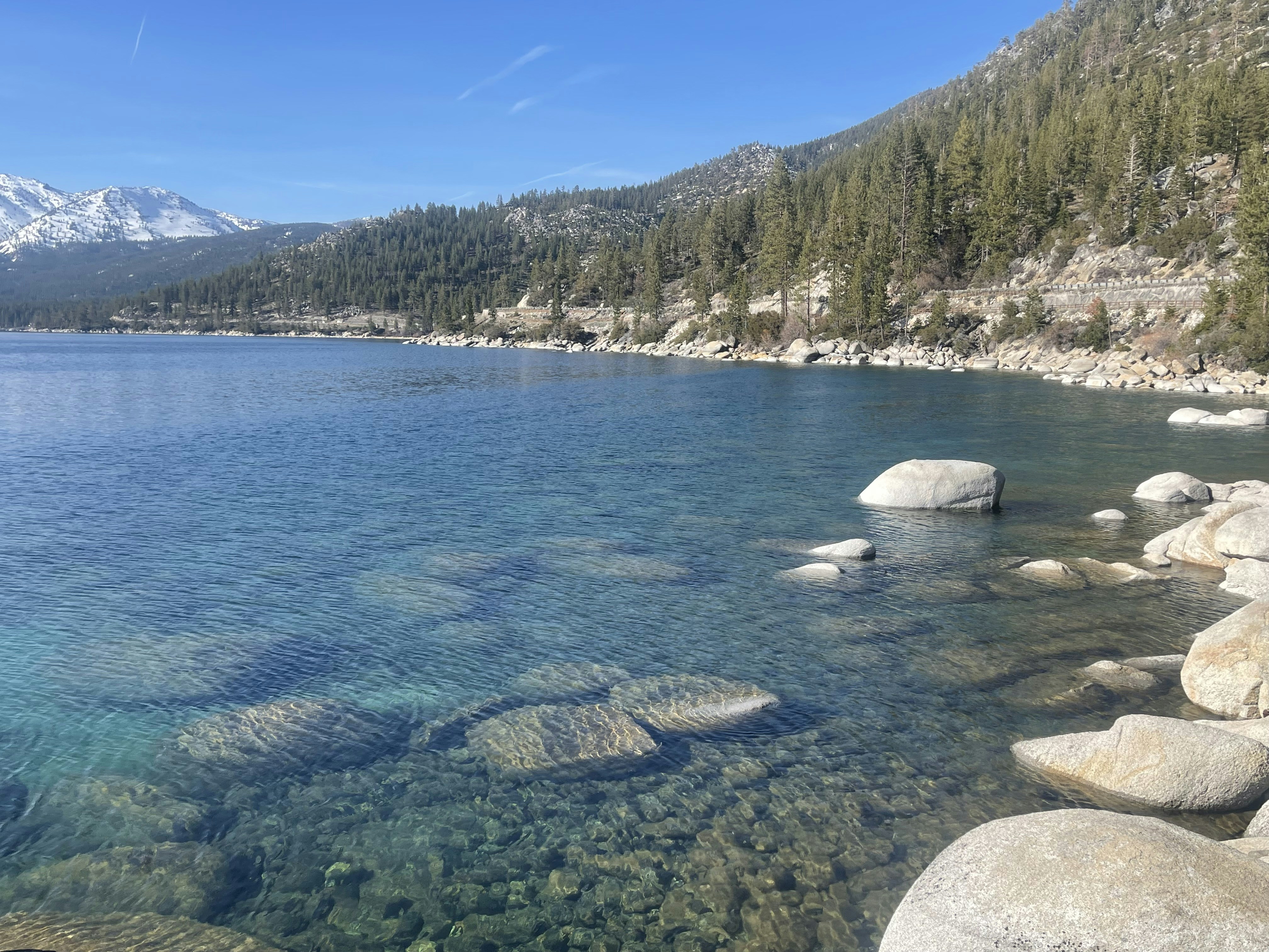 a body of water surrounded by rocks and trees
