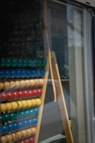 Close-up of children's hands moving beads on the abacus during a lesson.