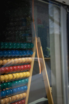 Close-up of colorful abacus beads with a lesson notebook in the background