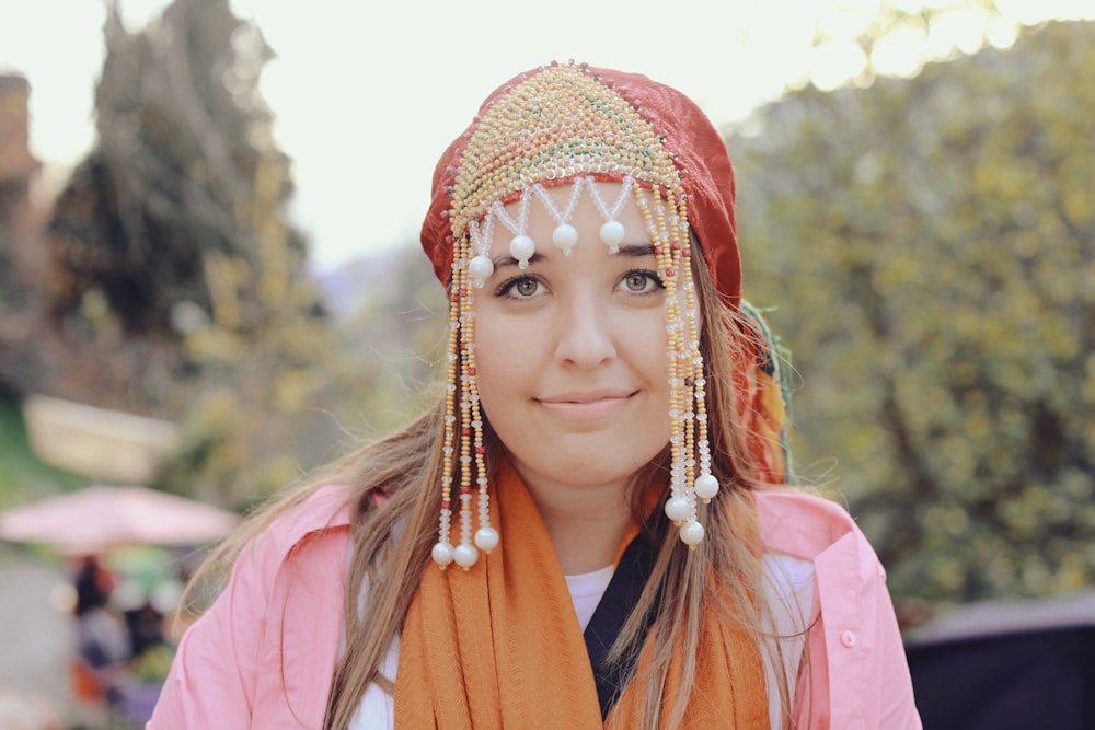 a woman wearing a head piece and a scarf