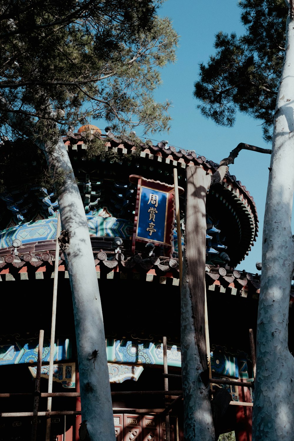 a building with a blue sign hanging from it's side