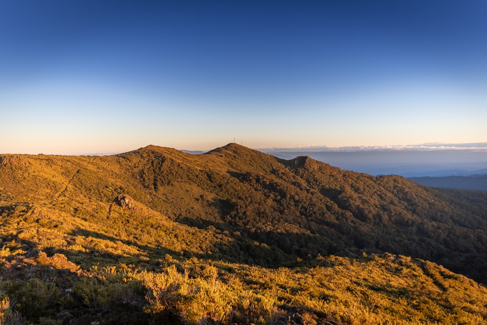 a scenic view of a mountain range at sunset