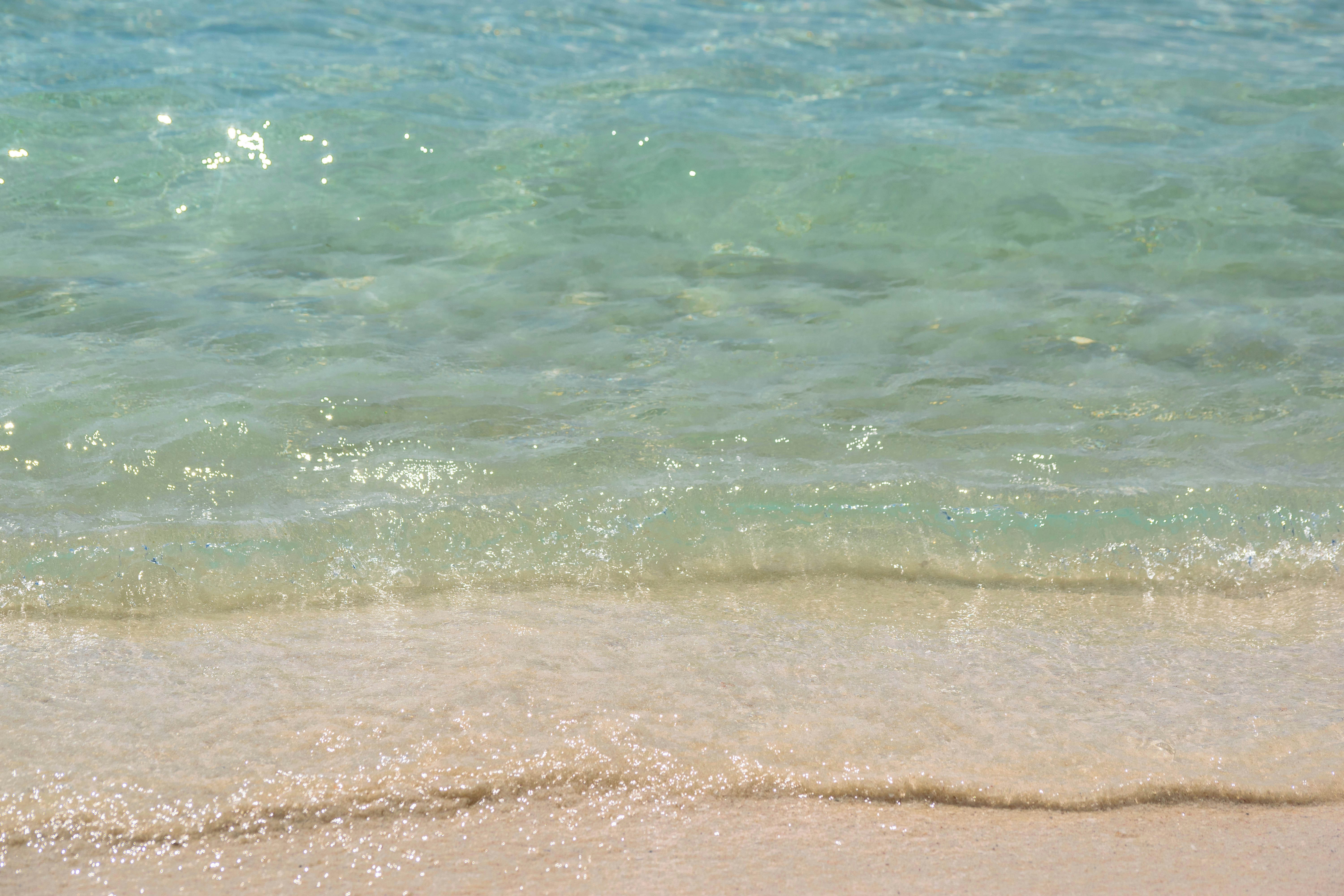 a sandy beach next to a body of water, Cancún offers a variety of activities for tourists and locals alike. Some of the best things to do in Cancun include swimming, snorkeling, walking, and scuba diving in cenotes. Other popular activities include visiting Chichén Itzá, Isla Mujeres, and other nearby attractions, other popular activities include visiting Chichén Itzá, Isla Mujeres, and other nearby attractions. tourists can also enjoy the nightlife, shopping, and dining in the city.