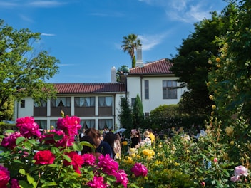 Family enjoying a sunny morning in the lush rose garden at the guest house.