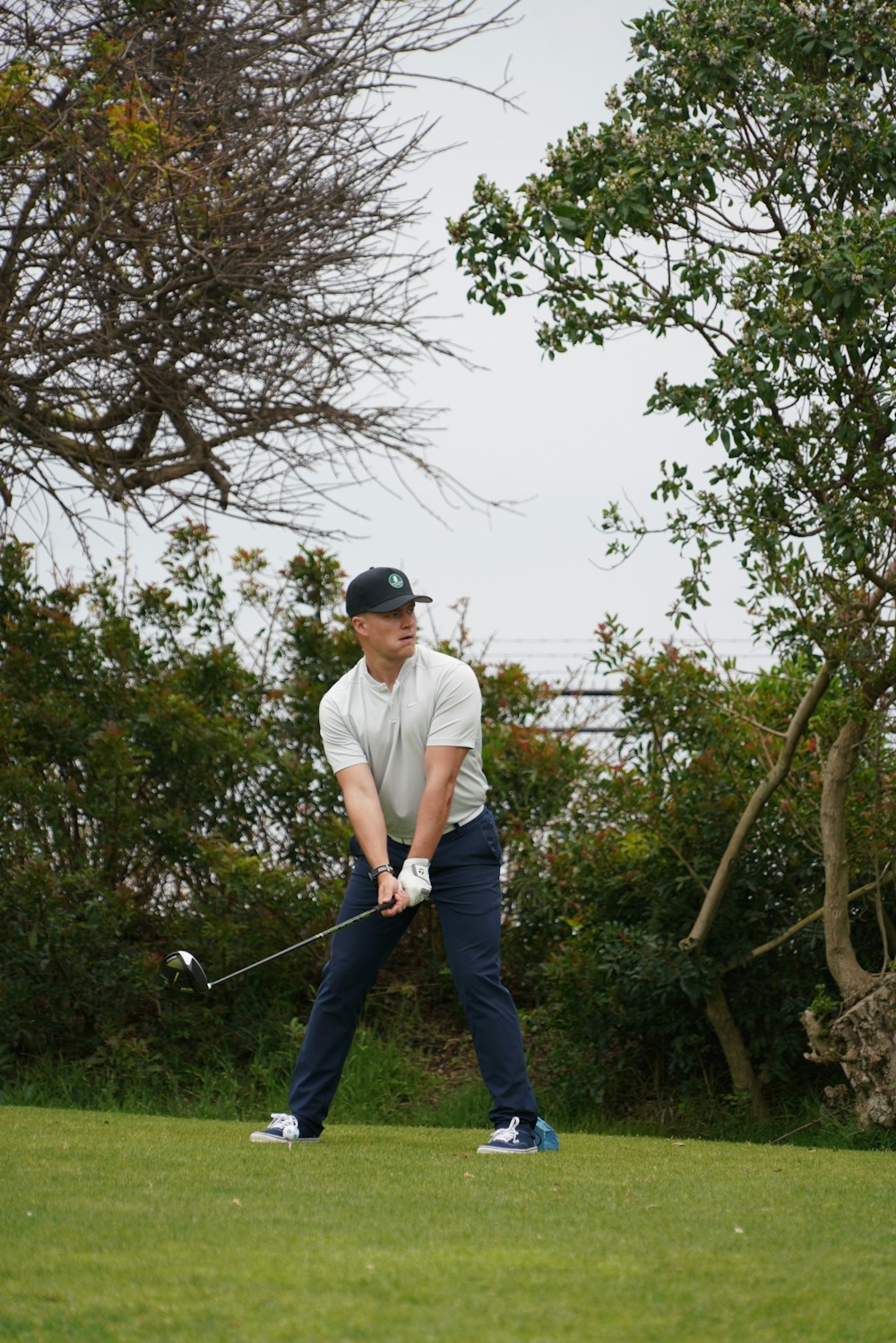 a man swinging a golf club on a golf course