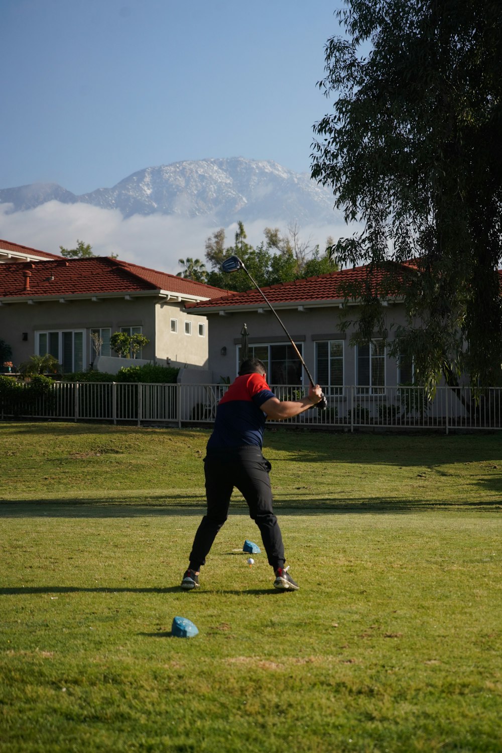 a person in a field swinging a baseball bat