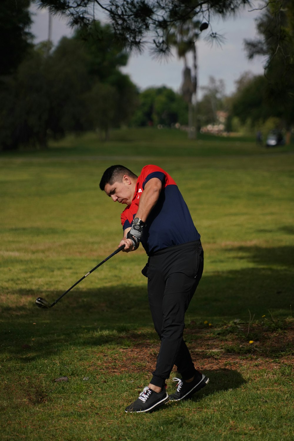 a man swinging a golf club at a ball
