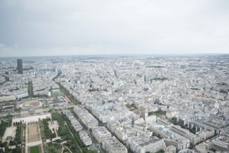 An aerial view of a sprawling urban project featuring interconnected green spaces and towering structures.
