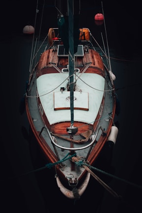 a sailboat docked in the water at night