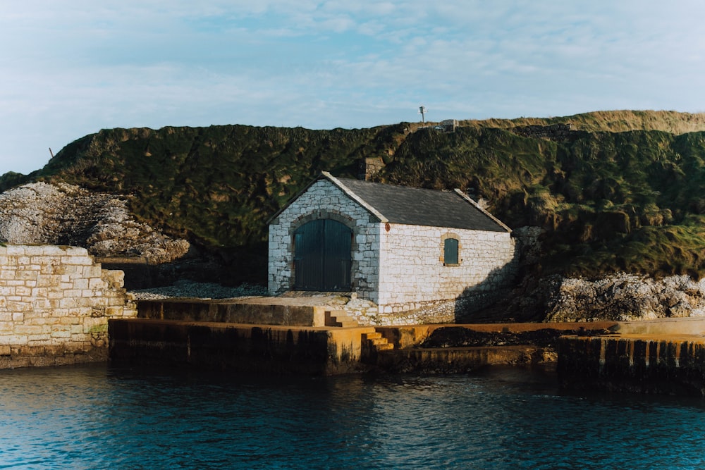 a small building sitting on top of a body of water