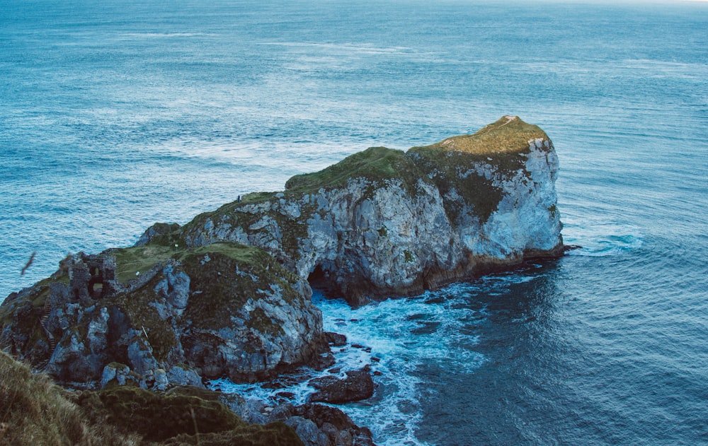 a rock outcropping in the middle of the ocean