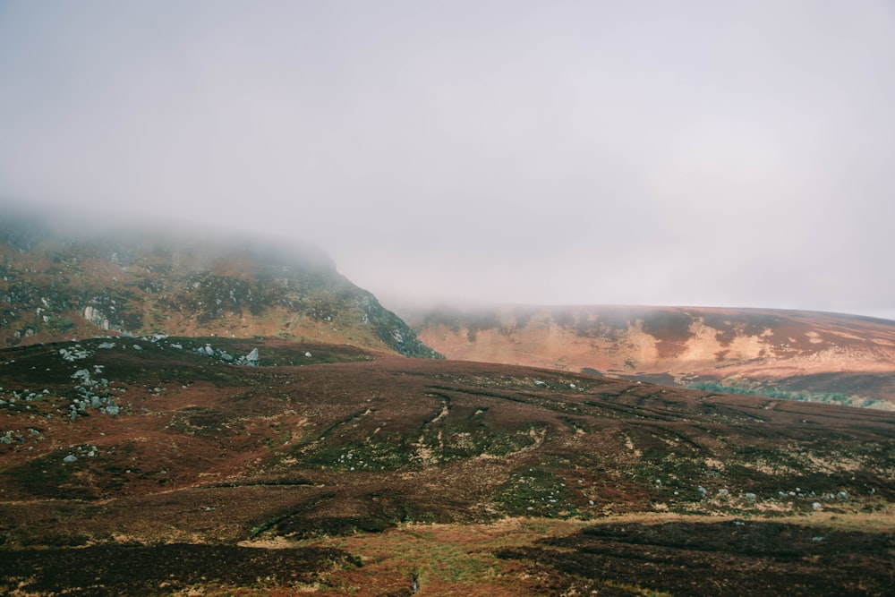 a view of a mountain with a cloud in the sky