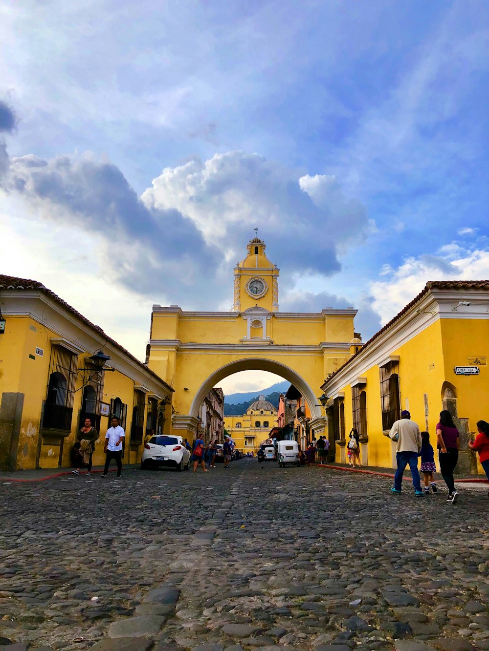 a group of people standing in front of a yellow building