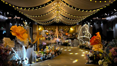 A beautifully decorated wedding venue with floral arrangements and soft lighting.