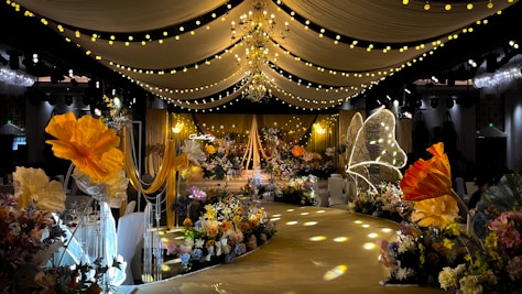 A vibrant event setup featuring elegant floral arrangements and warm lighting in Tamil Nadu.
