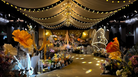 A beautifully decorated wedding venue showcasing floral arrangements and ambient lighting.