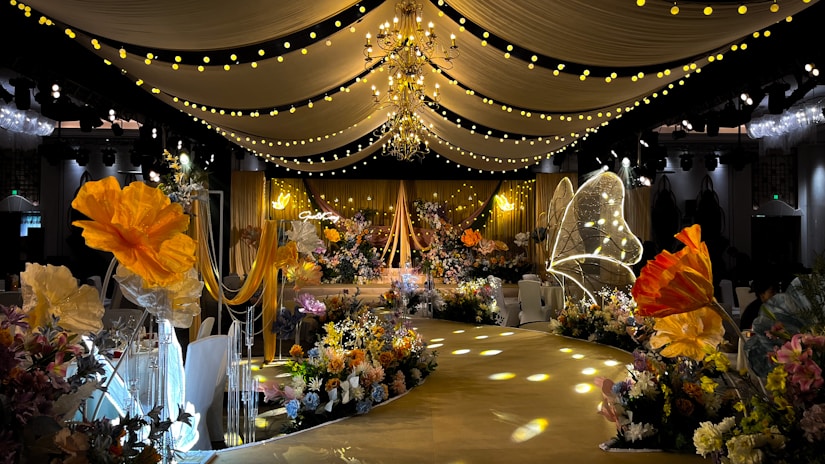 A beautifully decorated wedding venue with floral arrangements and soft lighting.