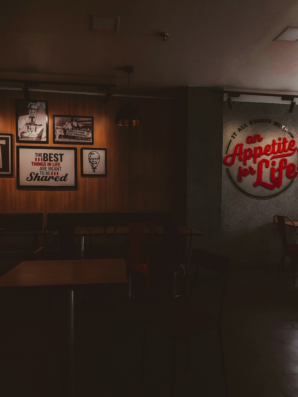 a dimly lit restaurant with posters on the wall