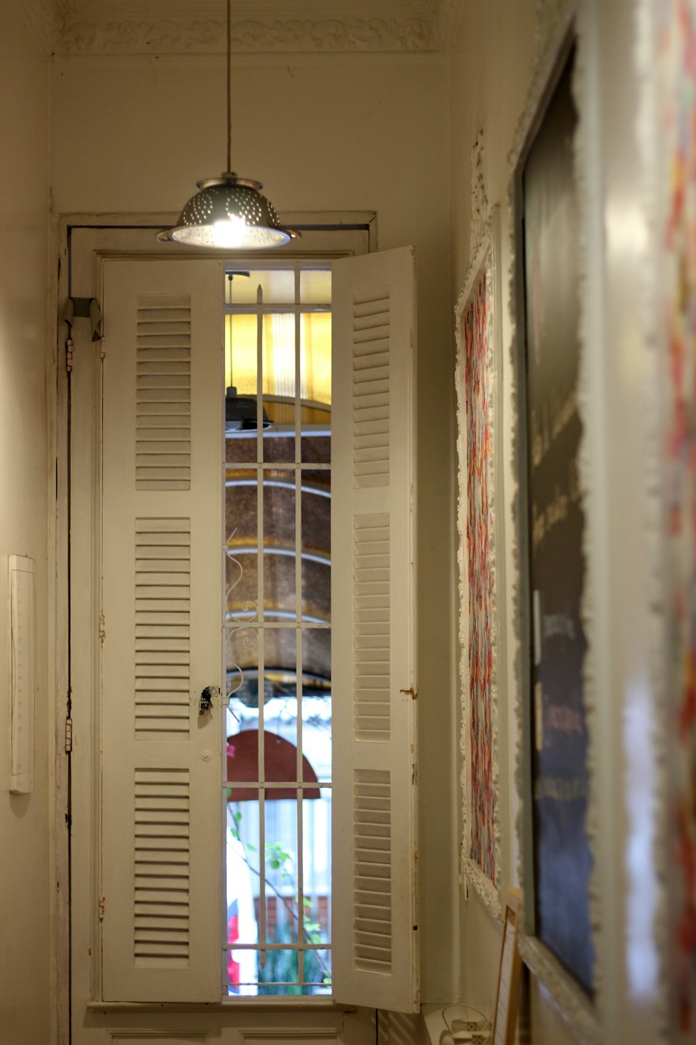 a hallway with a white door and a window