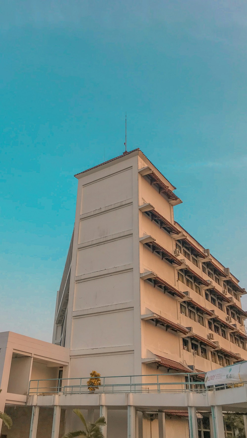 a tall white building with a sky background