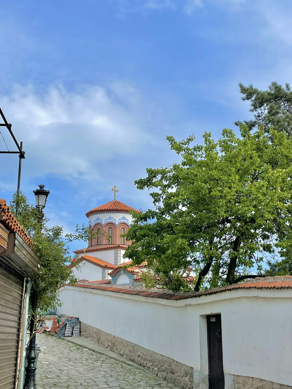 a cobblestone street with a church in the background