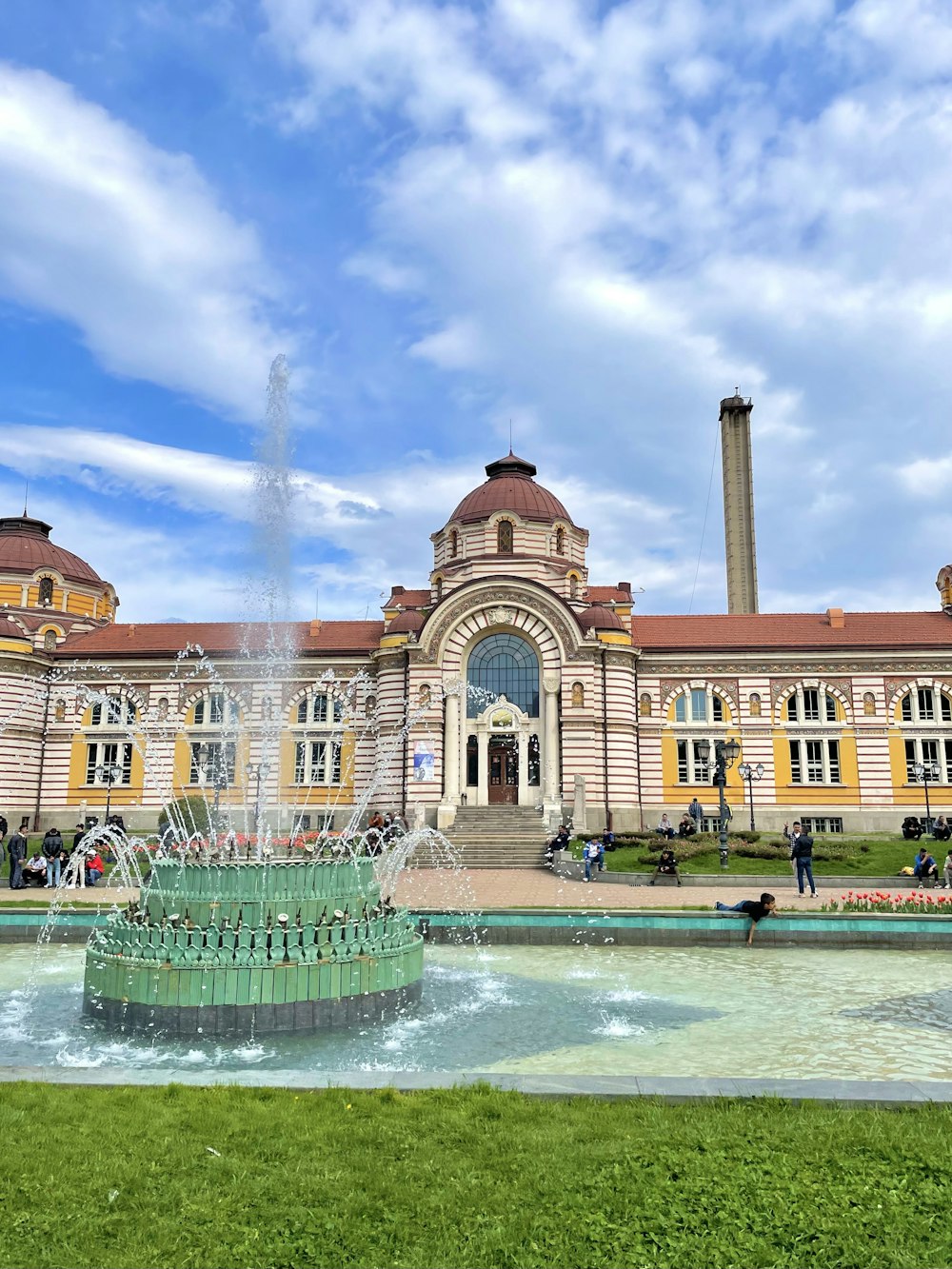 a large building with a fountain in front of it