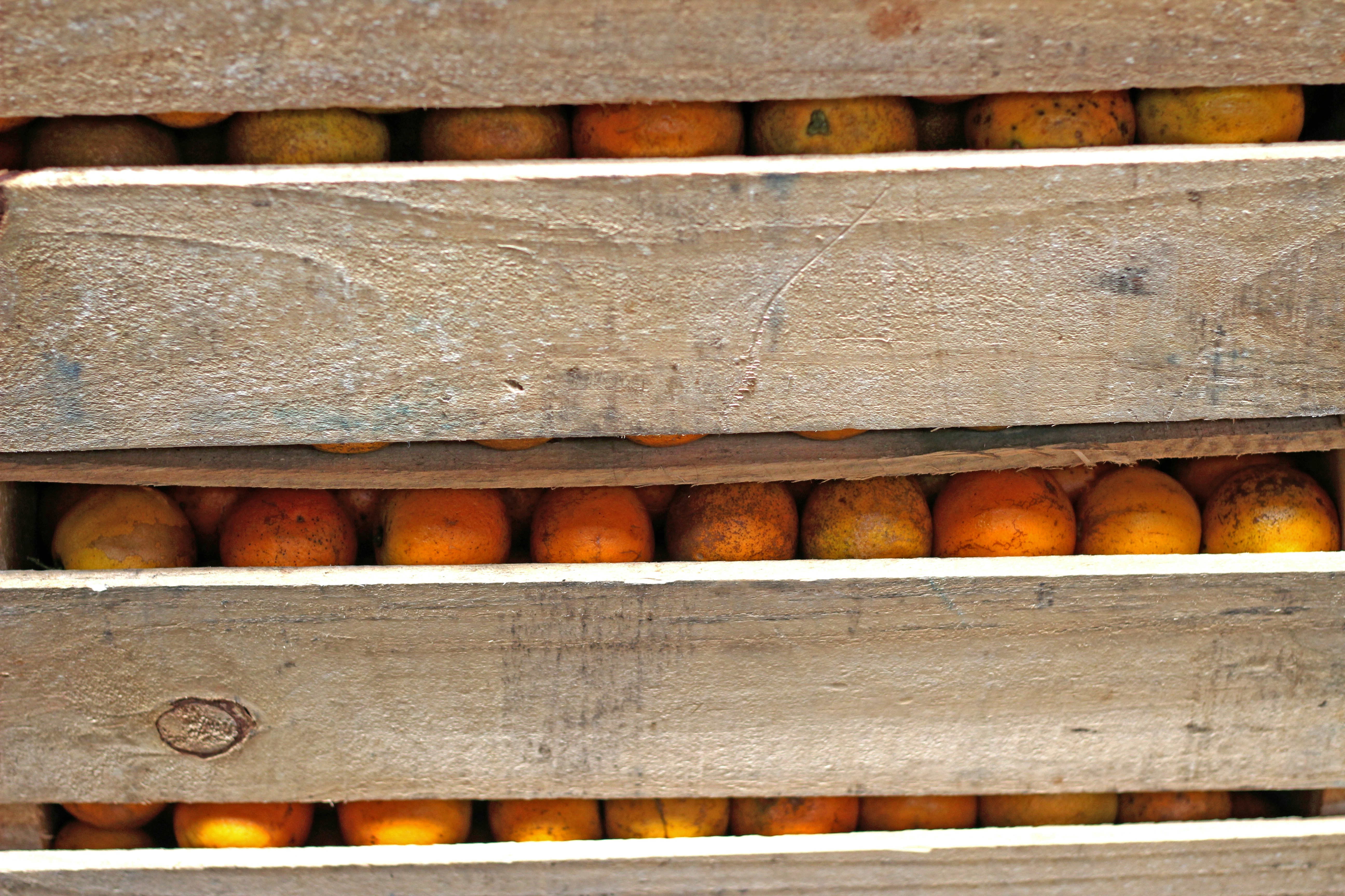 a wooden crate filled with lots of oranges
