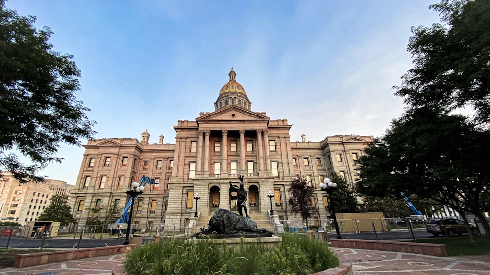 a large building with a statue in front of it